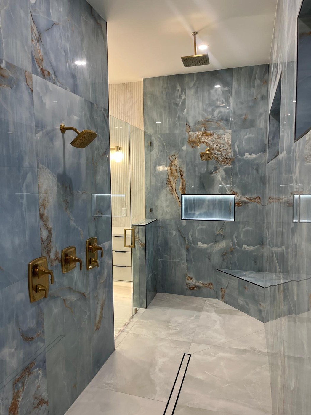 Blue onyx master shower with gold fixtures — 634 19th St SW