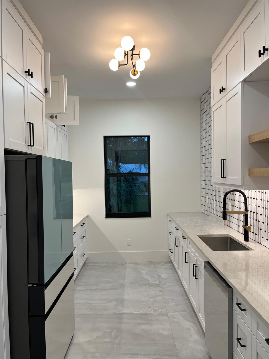 Kitchen with custom cabinetry and patterned backsplash