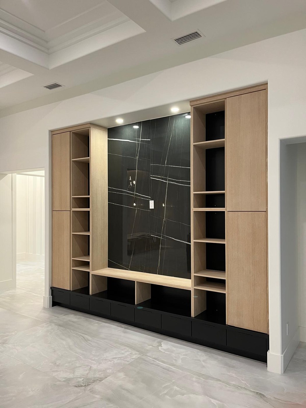 Black marble TV feature wall with oak millwork — 634 19th St SW