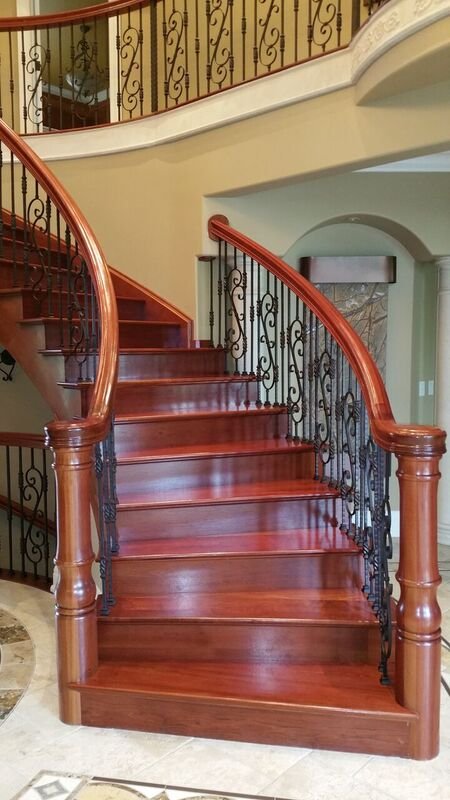 Curved staircase with stained treads and handrail